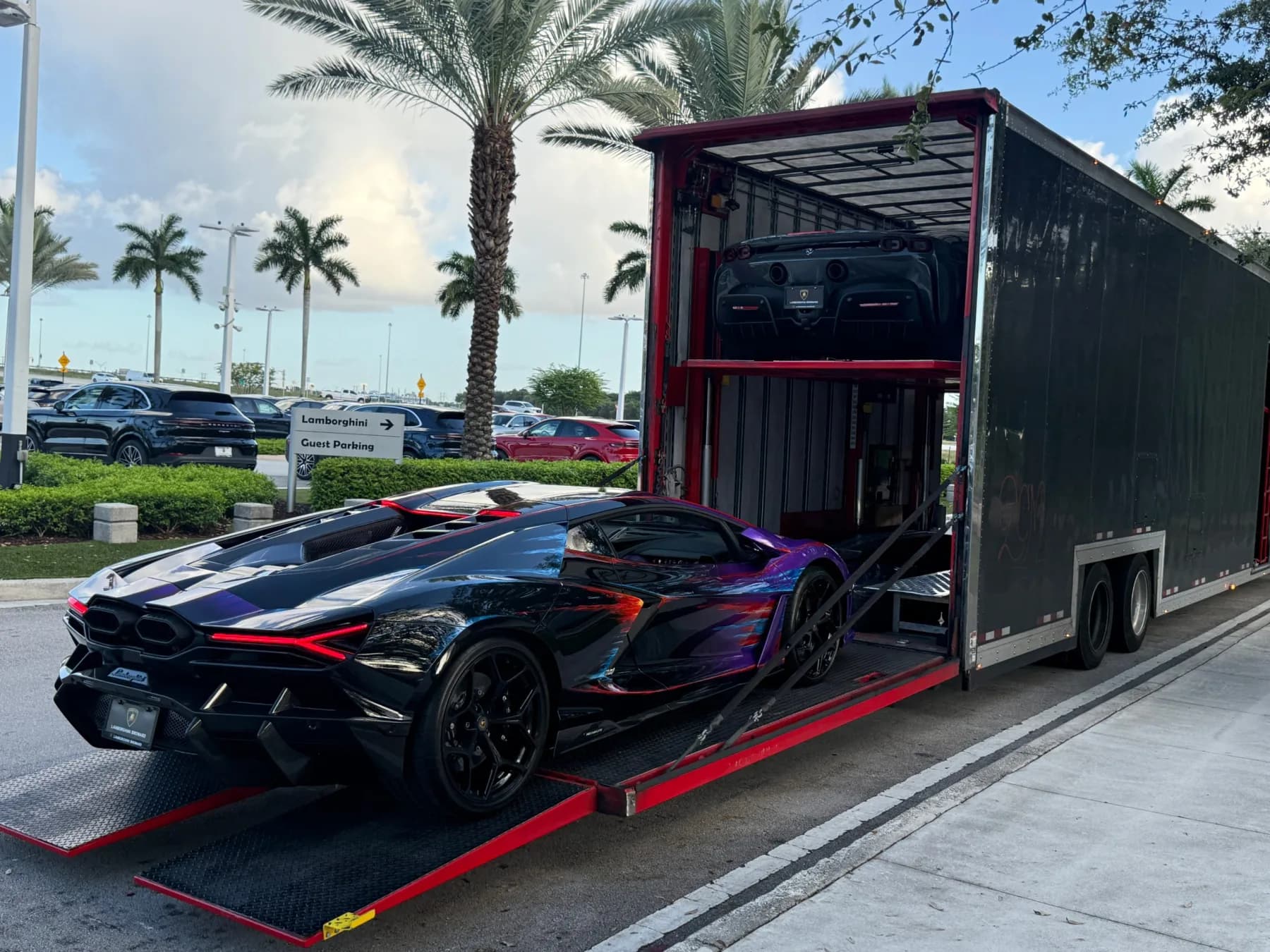Car being loaded into an enclosed auto transport trailer