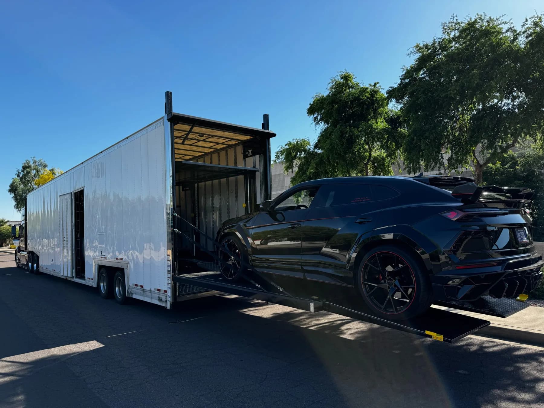 Vehicle on an enclosed carrier loading ramp