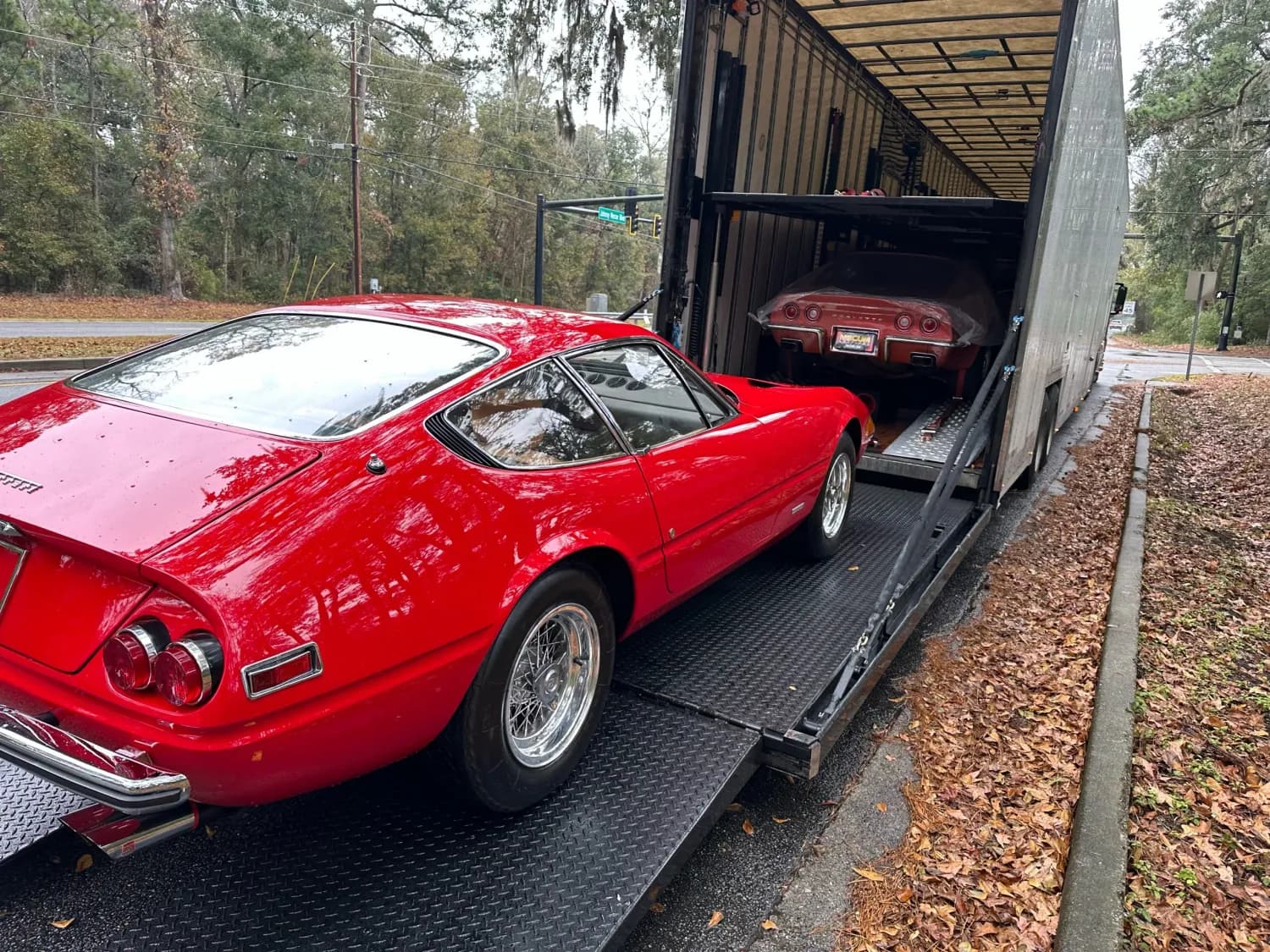 Red classic car inside an enclosed trailer