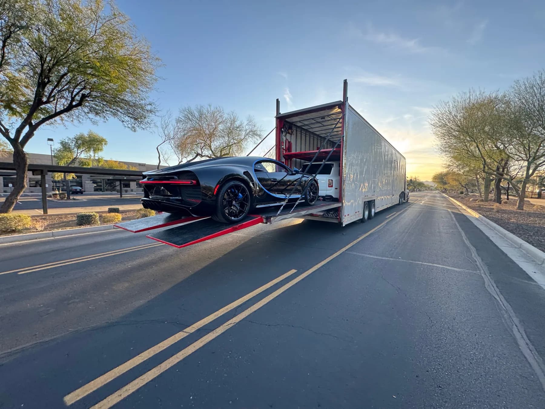 Sports car being loaded into an enclosed vehicle trailer